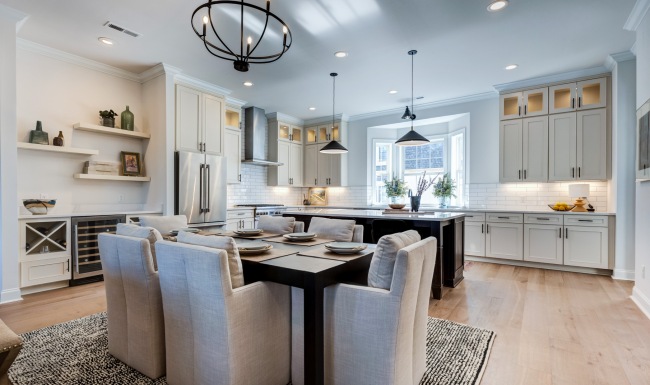 Spacious and well lit kitchen with wood floors and stainless steel appliances